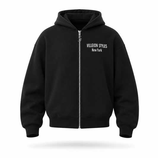 A black zip-up hoodie with a silver zipper and white text reading 'VILLEION STYLES New York' on the left chest, shown on a clean white background with a soft shadow underneath.
