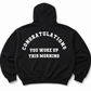 A black pullover hoodie shown from the back, featuring the phrase 'CONGRATULATIONS YOU WOKE UP THIS MORNING' printed in white arched text across the upper back.